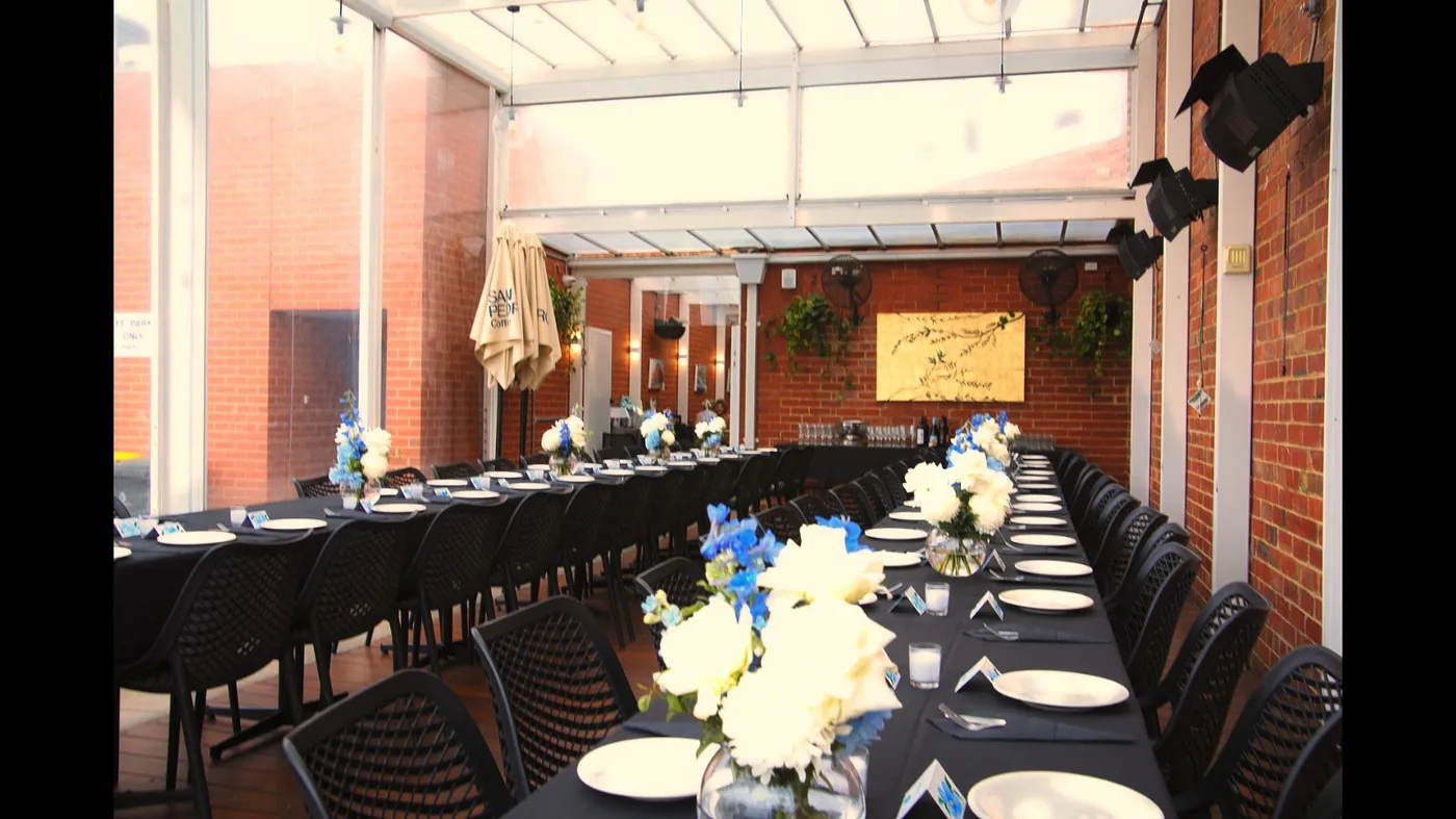 Private dining room set up for an event at Olive Lane, blue and white floral centrepieces