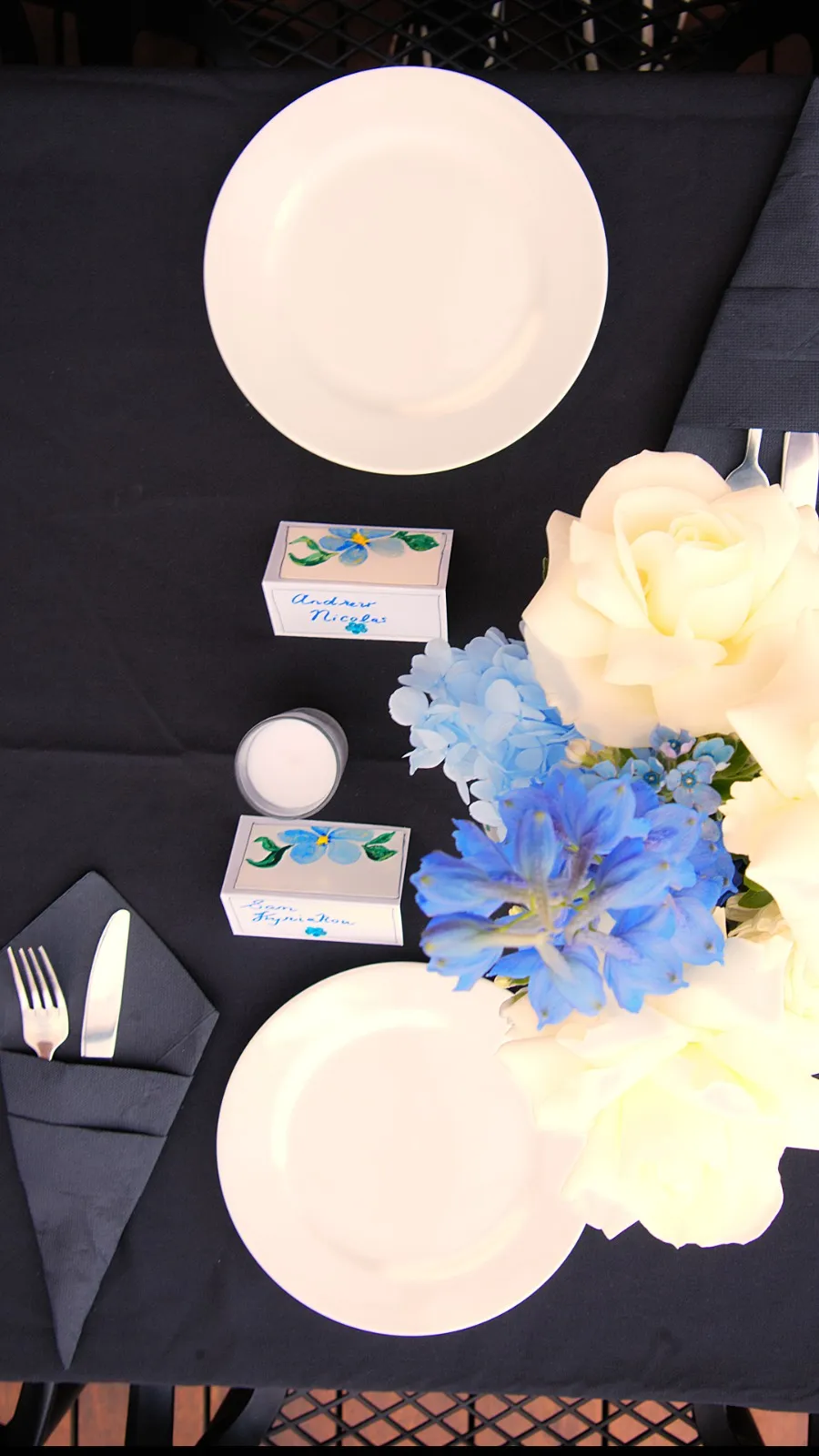 Close-up of a table place setting with floral decoration at an Olive Lane event