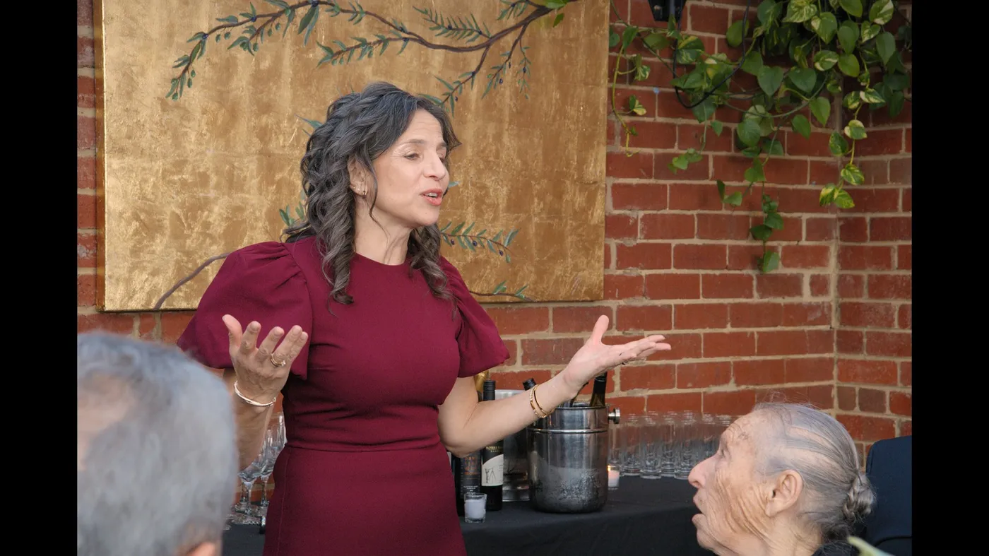 Guest addressing the room at an Olive Lane private event