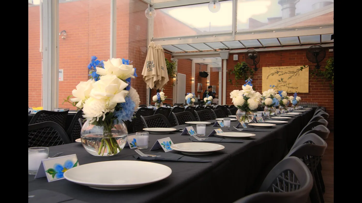 Table setting with white and blue floral centrepiece at an Olive Lane event