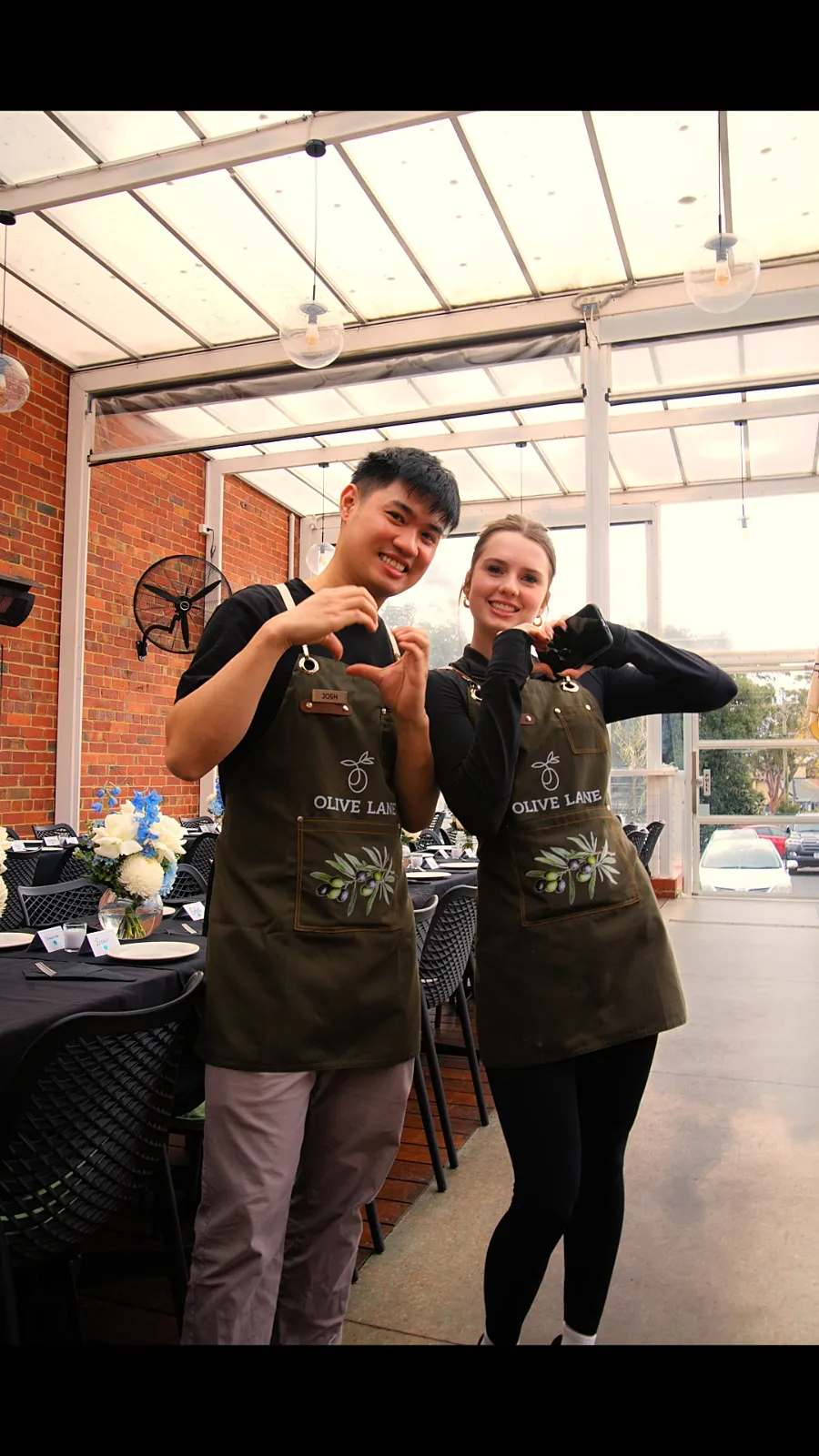 Olive Lane team members in branded aprons at a private event